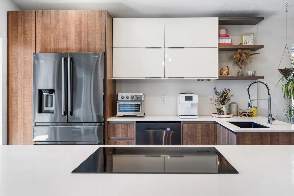 Kitchen with wood and white cabinets, open shelving and a black refrigerator